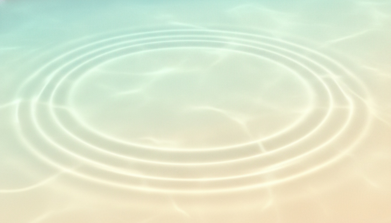 Soft concentric ripples spreading across sunlit shallow water
