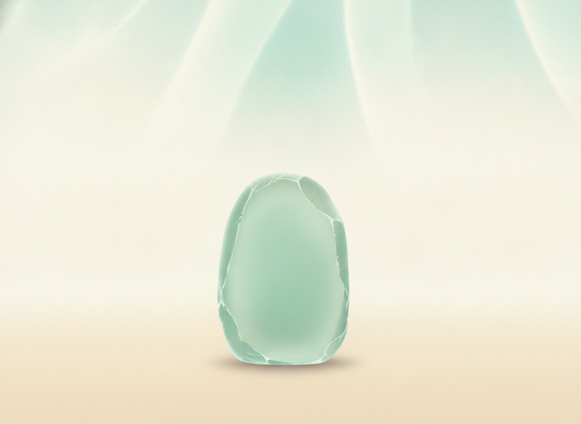 A tall sliver of seafoam-green sea glass standing upright